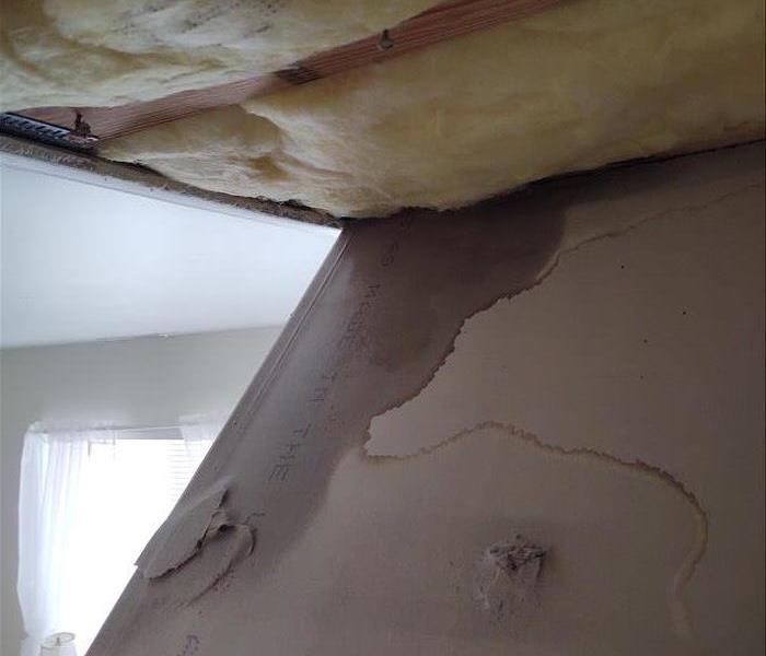 Water from an upstairs leak soaked through the insulation and into the ceiling on the first level.