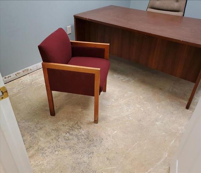 An empty office and empty desk chairs in a commercial building after a water damage.